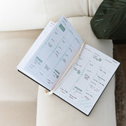 2024 a5 planner open resting on couch by Ronnie & Co